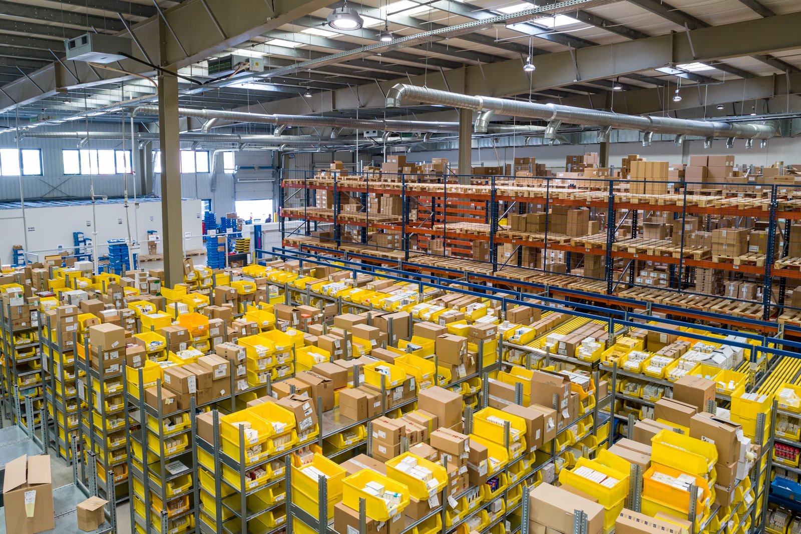 Commercial transport delivery distribution trucks backed up to cargo terminal bays